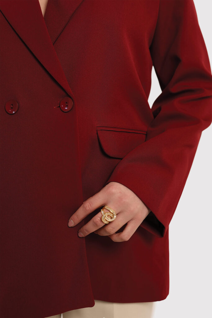 A model dressed in a beige sweater and matching pants stands confidently, showcasing a casual yet stylish outfit